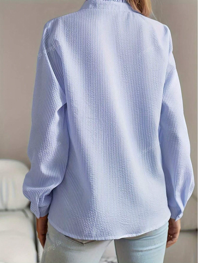 Chic button-up blouse for women, featuring a soft pleated ruffle hem